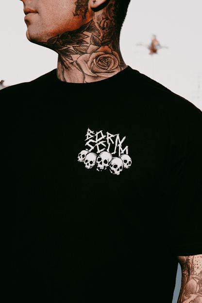 Never Sleepin' graphic tee — close-up of Born Scum skull logo on left chest of black t-shirt