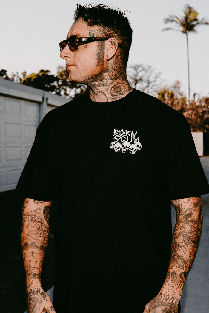 Never Sleepin' graphic tee on model — front view of black t-shirt with Born Scum chest logo