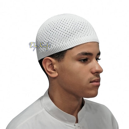 White knitted Islamic prayer cap (kufi) with breathable mesh pattern.